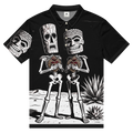Front view of Gracias de Corazón Performance Polo Shirt front — black all-over print with contrasting white stitching with tiki calavera skeletons and sacred hearts by Ropa Padre